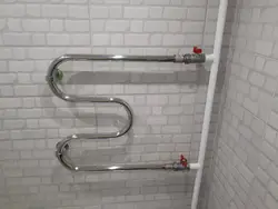 Heated towel rail photo in the bathroom in the apartment