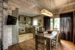 Interior of a combined living room and kitchen in a wooden house