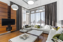 Interiors of a corner living room with two windows