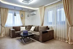 Interiors of a corner living room with two windows