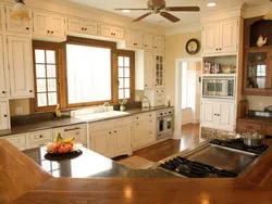 Kitchen in a country house with a window in the middle photo