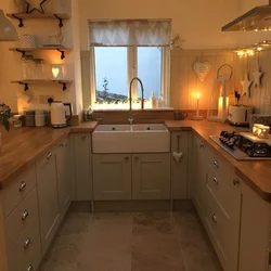 Design of a small kitchen in a house with a window