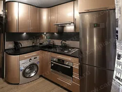 Corner kitchen with refrigerator and washing machine photo