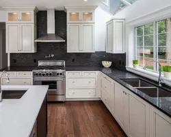 Kitchen with a gray countertop in a white interior and an apron