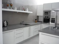 Kitchen With A Gray Countertop In A White Interior And An Apron