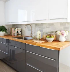 Kitchen with a gray countertop in a white interior and an apron