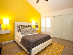 Yellow wall color in the bedroom interior