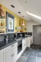 Gray floor and gray walls in the kitchen interior photo