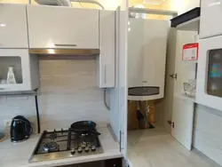 Photo of a kitchen with a gas pipe and water heater