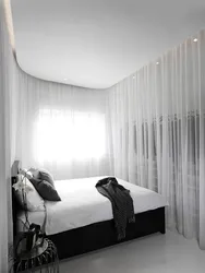 White curtains in the bedroom interior