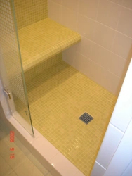 Photo of a bathroom with a tray instead of a bathtub