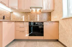 Peach-colored kitchen in the interior photo