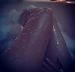 Photo of feet in bathtub with foam