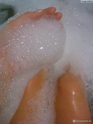 Photo of feet in bathtub with foam