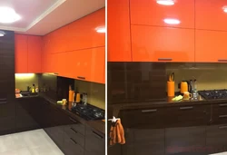 Orange-black kitchen in the interior photo