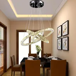 Modern chandeliers in the kitchen above the table photo