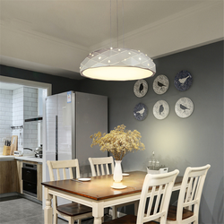 Modern chandeliers in the kitchen above the table photo