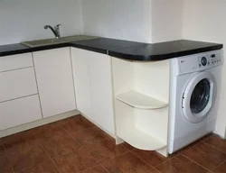 Washing machine in the kitchen under the countertop photo