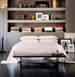 Bedroom interior with shelves on the entire wall