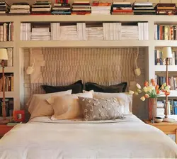 Bedroom interior with shelves on the entire wall