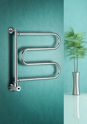 Electric heated towel rail in the bathroom photo