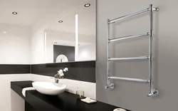 Electric heated towel rail in the bathroom photo