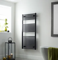 Electric heated towel rail in the bathroom photo