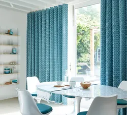 Blue curtains in the kitchen interior photo