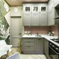 Interior of a small corner kitchen with a refrigerator