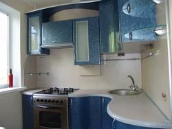 Interior of a small corner kitchen with a refrigerator