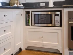Photo of a kitchen with a microwave in a niche