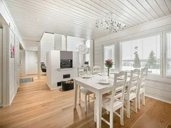 White kitchen in a wooden house in the interior