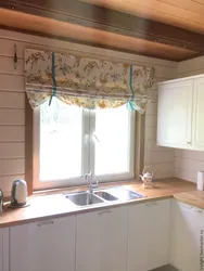 Curtains in the kitchen in a wooden house photo