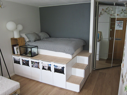 Podium bed in the bedroom interior
