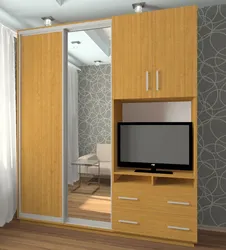 Sliding wardrobes with a niche for a TV in the bedroom photo