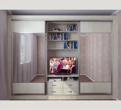 Sliding wardrobes with a niche for a TV in the bedroom photo