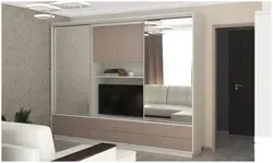 Sliding wardrobes with a niche for a TV in the bedroom photo