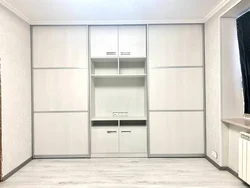 Sliding wardrobes with a niche for a TV in the bedroom photo