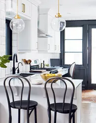 White kitchen black table in the interior