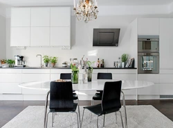 White kitchen black table in the interior
