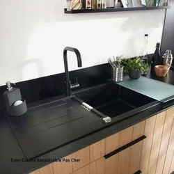 Photo Of A Kitchen With A White Countertop And A Black Sink