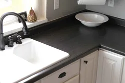Photo Of A Kitchen With A White Countertop And A Black Sink