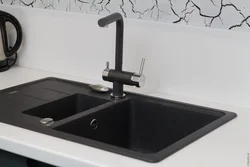 Photo Of A Kitchen With A White Countertop And A Black Sink