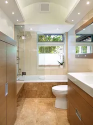 Interior of a bathroom with a toilet in a house with a window