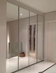 Modern sliding wardrobe in the hallway with a mirror photo design