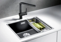 Kitchen sinks built into countertops made of artificial photo