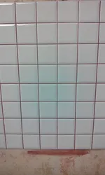 Grout on white tiles in the kitchen photo