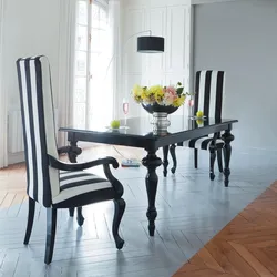 White table with black chairs in the kitchen interior