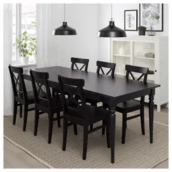 White table with black chairs in the kitchen interior