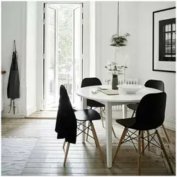 White table with black chairs in the kitchen interior